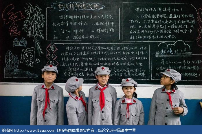 The male and female pupils wear identical uniforms which consist of grey button-ups jackets neckerchiefs and caps 