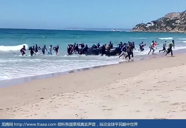 Embarking: Some two dozen people reportedly African migrants jump off the boat and run onto the beach in front of surprised sunbathers and tourists