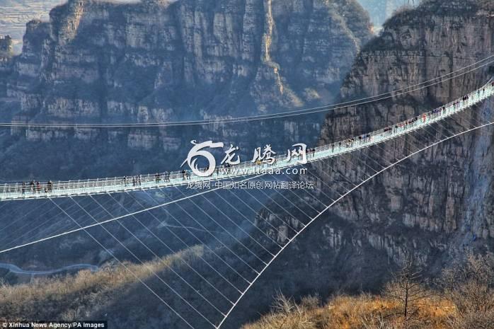 Don't look down! The 1601-foot-long glass-bottomed bridge opened on December 24 in the Hongyagu Scenic Area in China