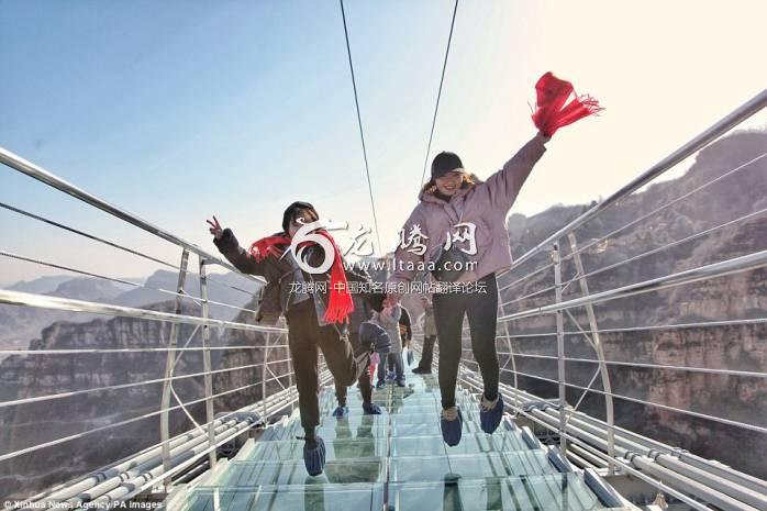 Daredevils: Tourists jump on the transparent suspension bridge  which has been designed to sway 755 feet above the ground