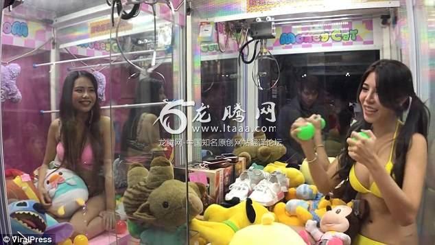 Two of the girls sit in among the toys and prizes which include a pair of trainer and cuddly toys