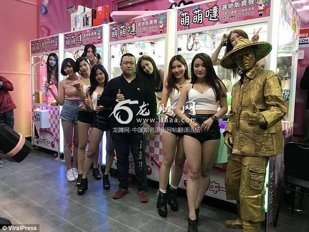 The models line up in hot pants next to the arcade machines they ended up inside at the attraction