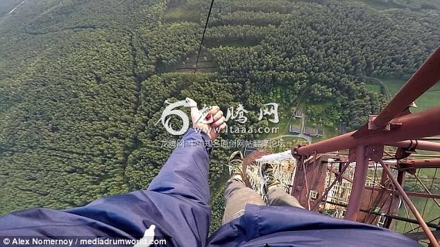 Relaxed: Alex Nomernoy 19 ascends the huge operating tower in Russia with no safety equipment giving a thumbs up to the camera when he reaches the top