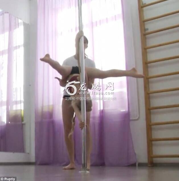 The girl performs moves like that of an acrobat under the guidance of her teacher