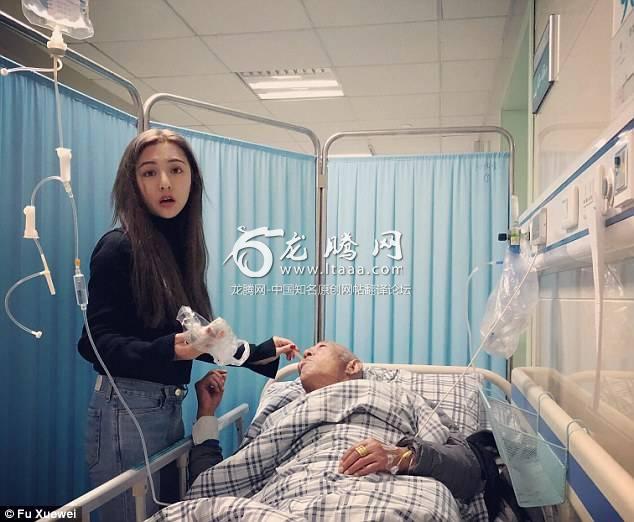 Ms Fu is pictured feeding her grandfather in the hospital.  Ms Fu's perspective on life and family was changed after her grandfather fell seriously ill last year