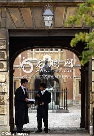 An Eton College pupil talks to a master in the entrance to School Yard