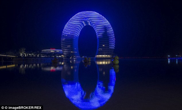 Sheraton Hot Spring Resort, lit up at night, in Huzhou, Zhejiang. The luxury hotel and resort has earned itself nicknames such as 'Horseshoe Hotel' and 'Doughnut Hotel'