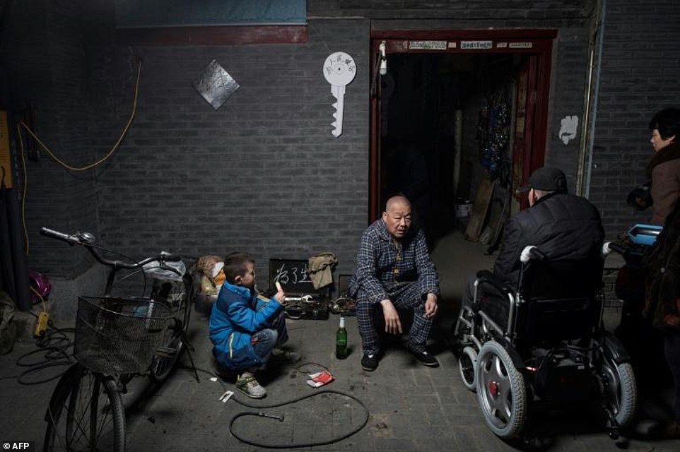 Bicycles and motorbikes are the best ways to get around the disorienting alleyways which can resemble mazes and would confuse any first-time visitors. Pictured is a neighbourhood bike repair shop with a signboard saying 'all for making a living'