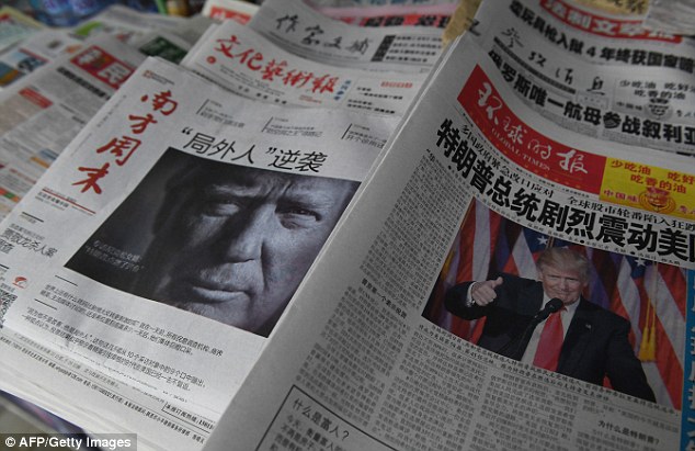 Trump has been attacked in recent days in in China's People's Daily and the Global Times newspaper's Chinese edition. Pictured are Chinese papers on November 10 in Beijing.