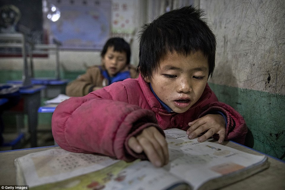 The tragedy behind the economic boom: Young Luo Hongniu aged eight is being raised by his grandparents in the rural province of Anshun