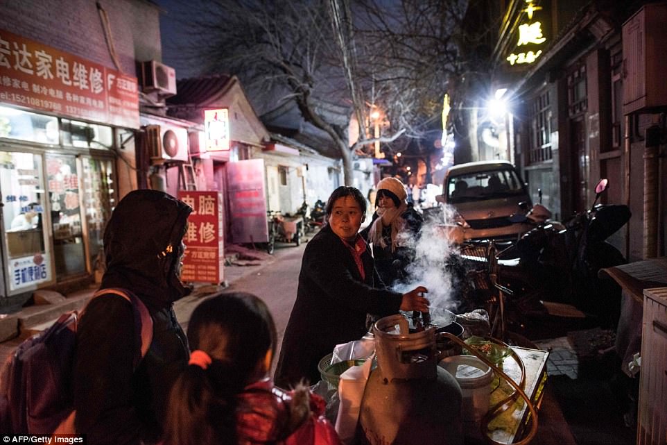 The narrow streets are filled with vendors selling breakfast snacks from small stalls - crisp-fried egg crepes steamed dumplings and warming bowls of millet porridge. These stalls are usually right outside residents' families