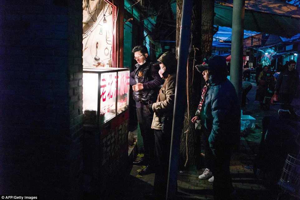 Fruit vendors butchers and convenience shop owners start their days by setting stools out on the street while residents wrap up their day with a takeaway meal from many of the food stores in hutong