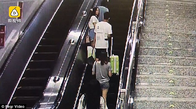 The woman turns around as soon as the man touches her buttocks on the escalator