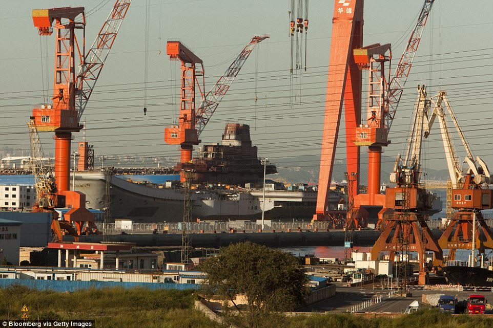 The 1000ft ship started life as one of the Soviet unx's last carriers under construction before being sold by Ukraine as a stripped down hulk to private Chinese interests in 1998. It is pictured here at a dry dock at a port in Dalian Liaoning province China in 2009 before its refit