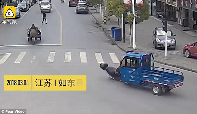 The truck driver knocks down a man from his scooter near a traffic junction in Ru Dong China