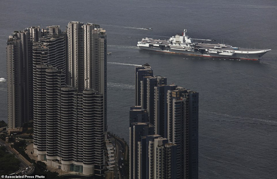Setting sail: The Liaoning China's first aircraft carrier arrives in Hong Kong for a port call today to celebrate the 20th anniversary of the People's Liberation Army (PLA) garrison's presence in the semi-autonomous Chinese city