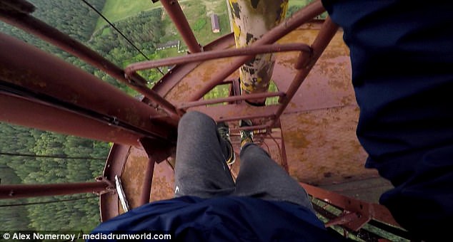 Nerve wracking: He can be seen shimmying up dozens of narrow bars during the terrifying expedition