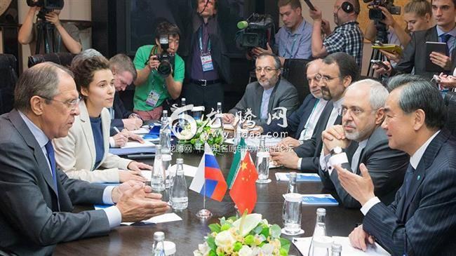 Russian FM Sergei Lavrov left Chinese FM Wang Yi right and Iran’s FM Mohammad Javad Zarif second right are seen during a trilateral meeting as part of the high-level conference on security and stability in the SCO region.