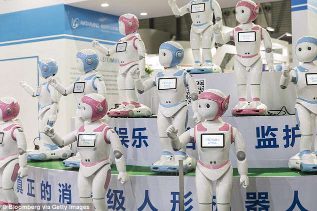 The humanoid device stands as tall as a five-year-old moves and dances on wheels and its eyes keep track of its charges through facial recognition technology. Buyers at CES watched a performance of several iPals dancing in unison at the event (pictured)