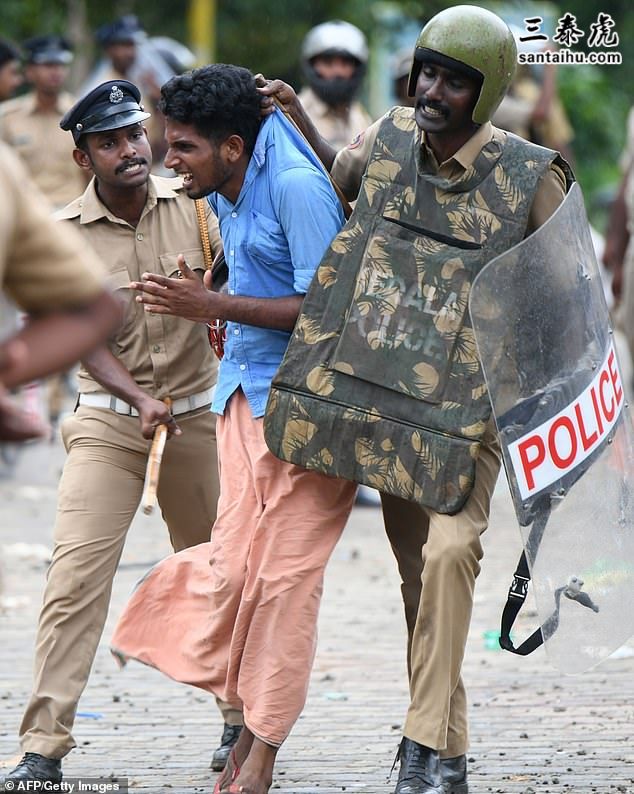 5154022-6289429-Indian_police_remove_a_protester_yesterday_a